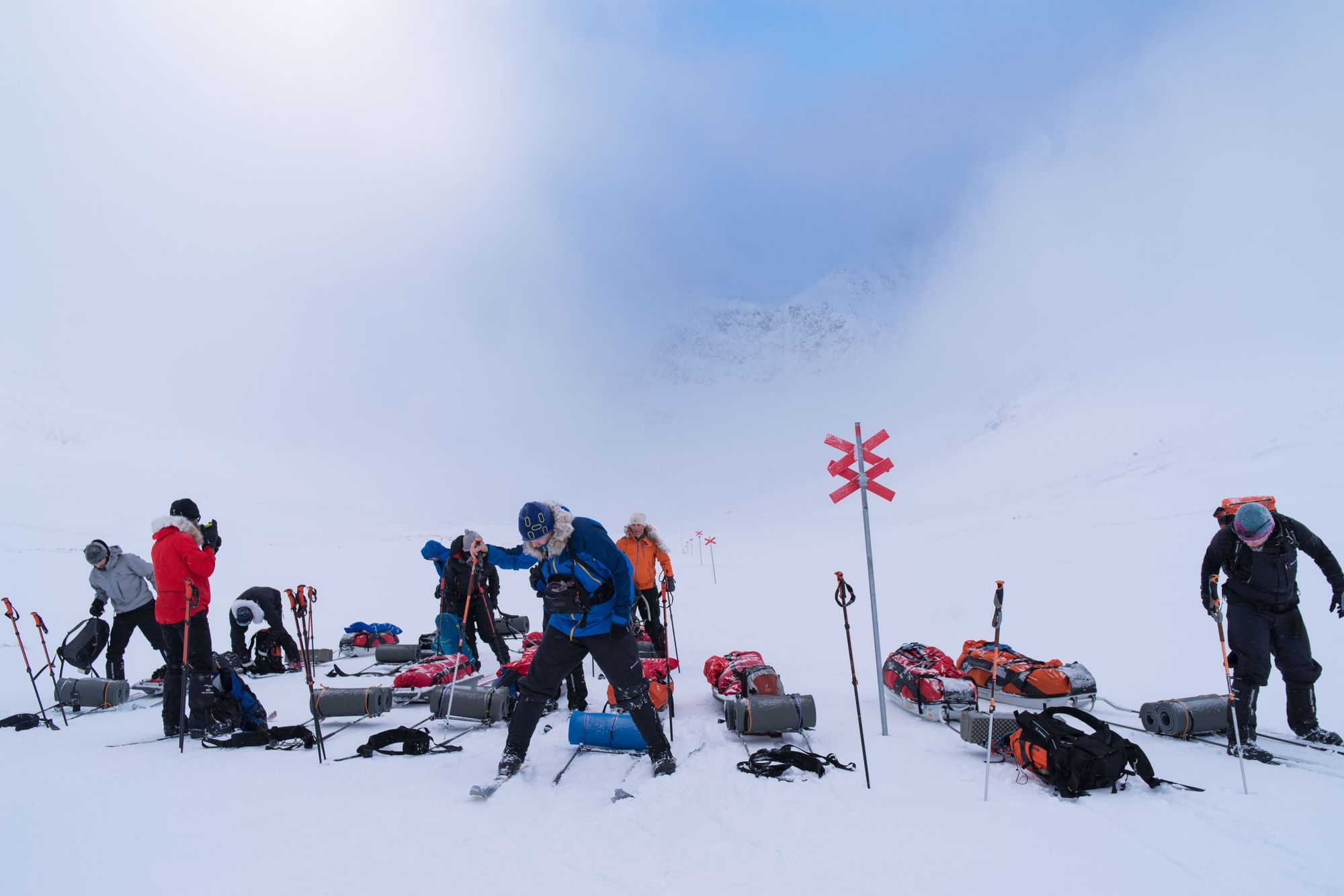 A training group working with stoves and equipment in the snow